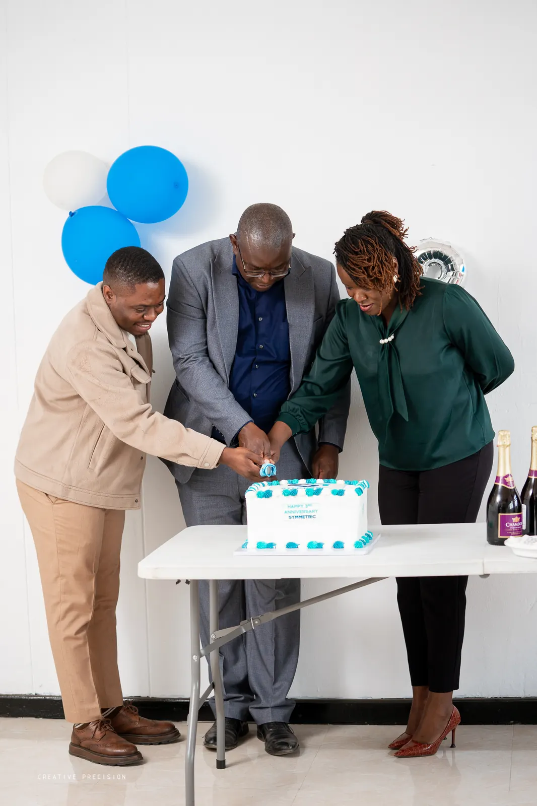 Directors cutting the third-anniversary cake